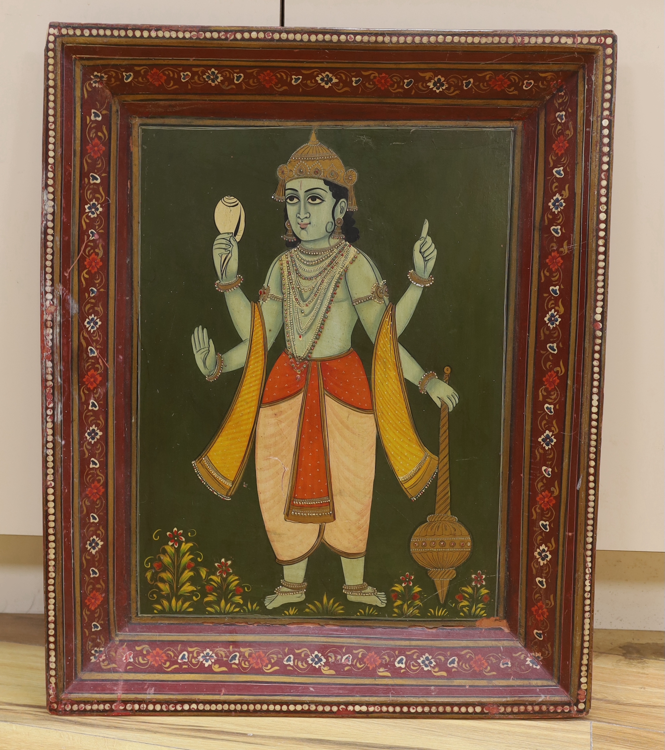 Indian school (20th century), painting of a Hindu deity in a painted frame, total size 73 x 59 cm
